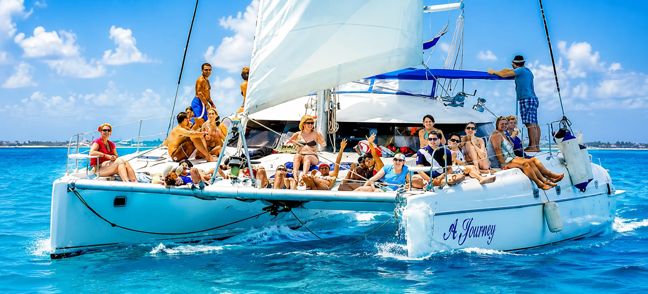Cancun catamaran sailing excursion with guests enjoying the Caribbean Sea