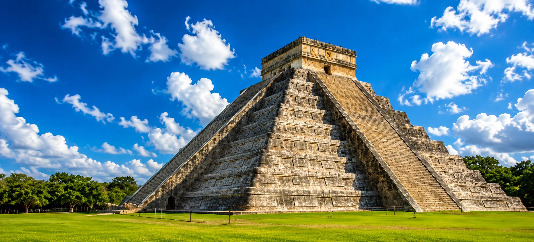 Chichen Itza Mayan pyramid under a blue sky, a highlight day trip from Cancun