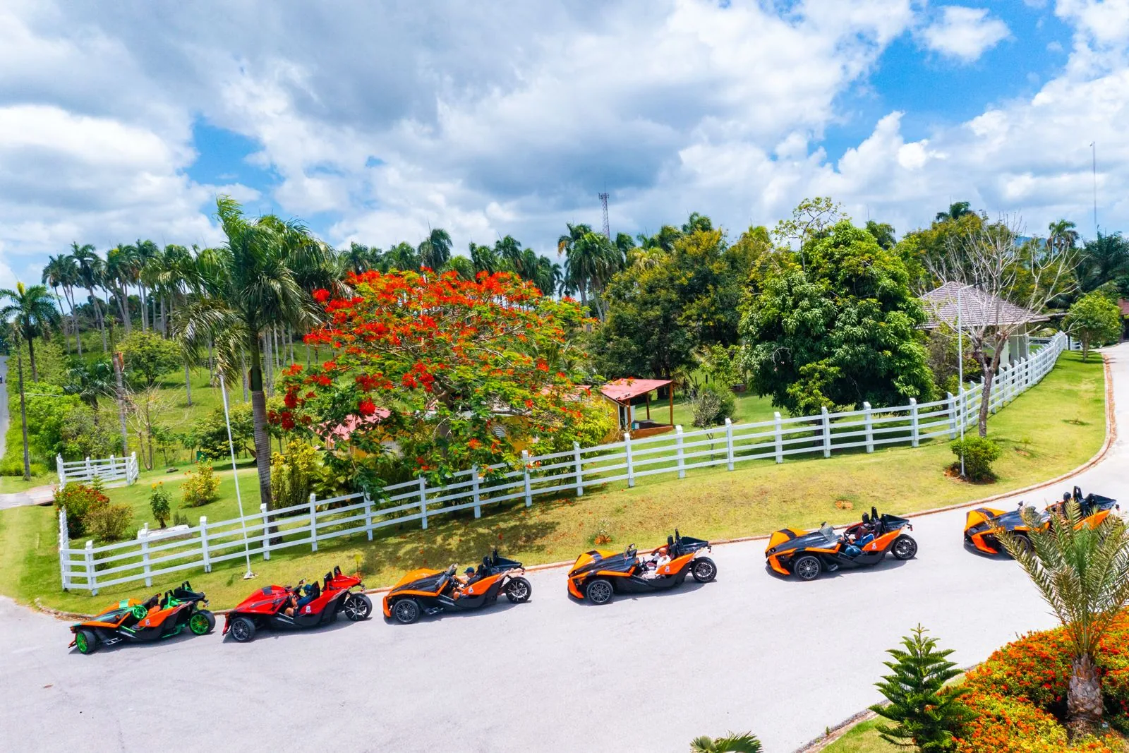 Polaris Slingshots driving through tropical countryside near Macao